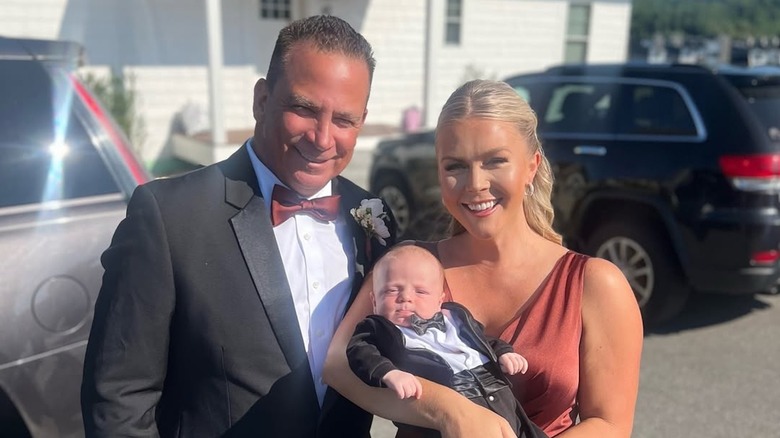 Karoline Leavitt holds her son while standing next to husband Nicholas Riccio