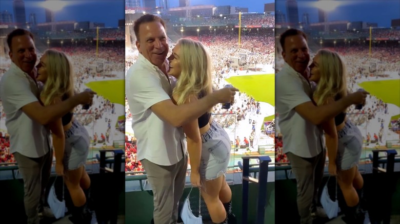 Karoline Leavitt and Nicholas Riccio embrace at a ball game