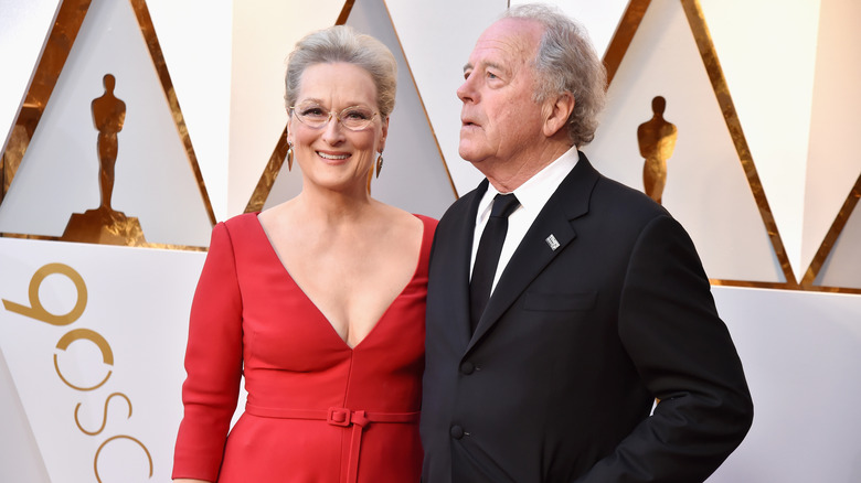 Smiling Meryl Streep and serious Don Gummer on red carpet