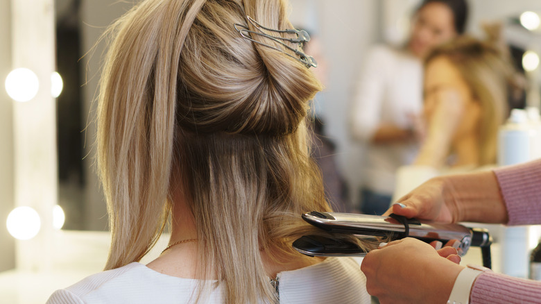 woman getting hair straightened