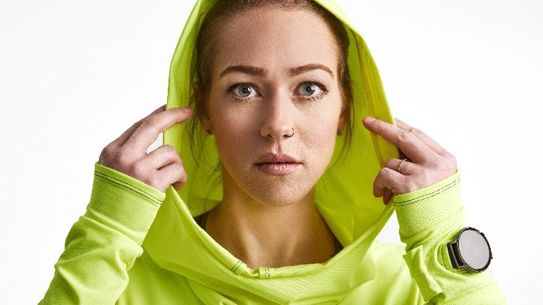 Woman wearing hooded running shirt