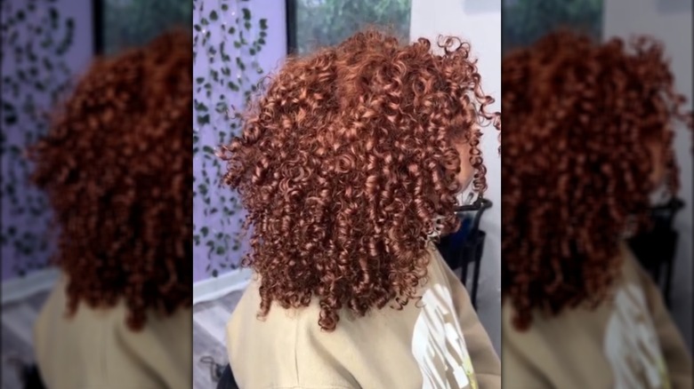 Side view of curly, copper hair