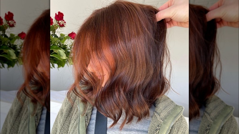 Side view of red-brown hair with orange pieces towards the face