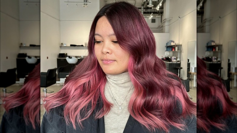 Woman with strawberry brunette hair and pink underdye