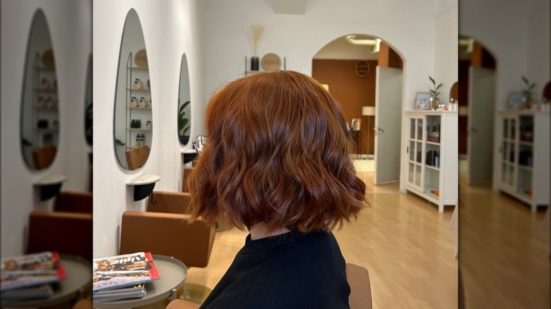 Side view of short, choppy bob in strawberry brown