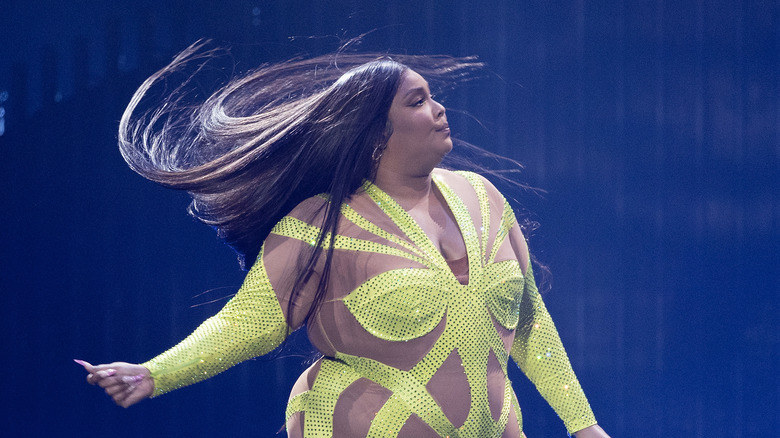 Lizzo performing in yellow jumpsuit