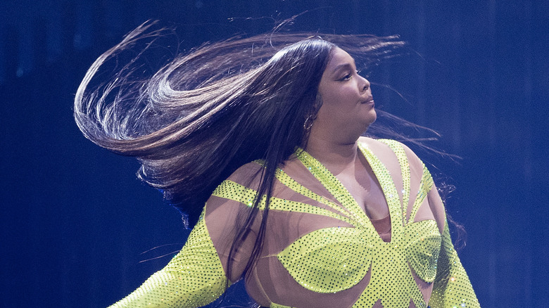 Lizzo performing in yellow jumpsuit