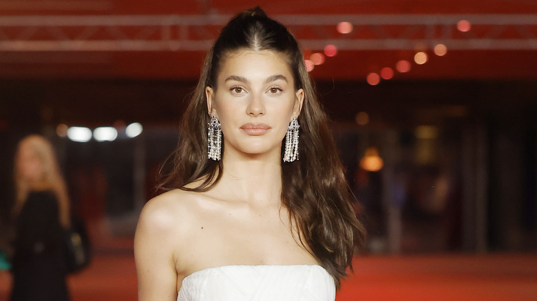 Camila Morrone with a half-up half-down hairstyle