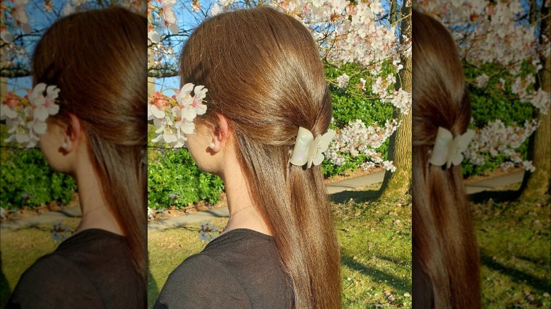 woman with low pony and butterfly clip 