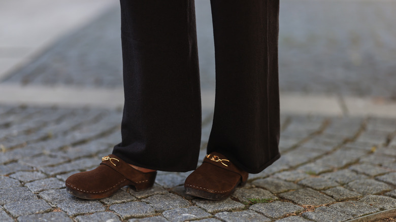 Brown clog shoes on pavement