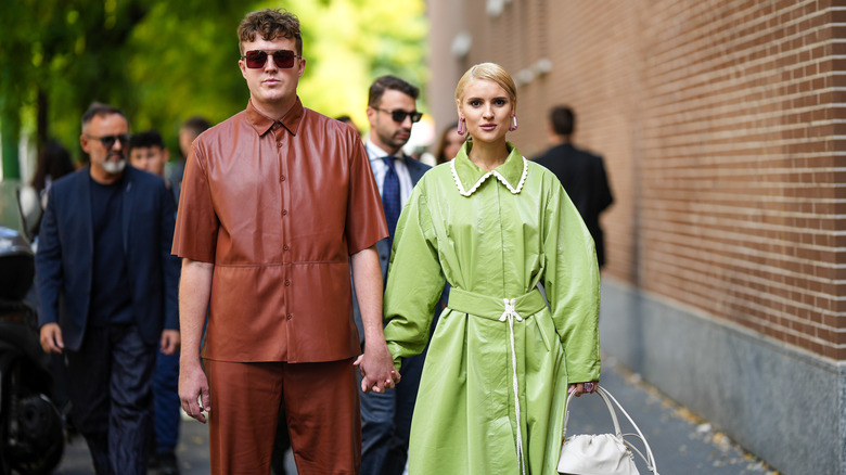 Couple holds hands in all leather outfits