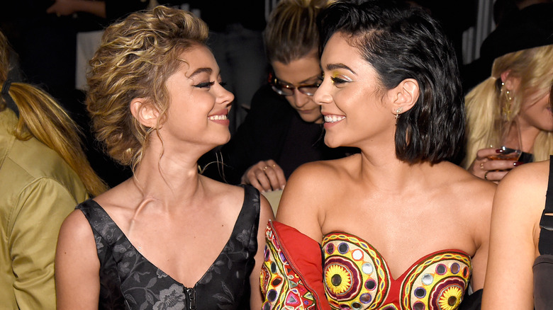 Sarah Hyland and Vanessa Hudgens facing each other