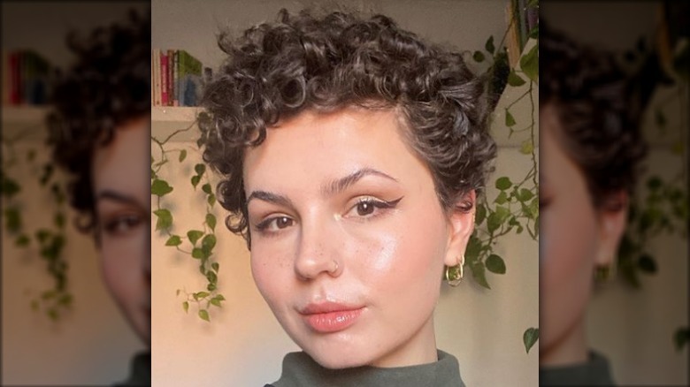 Person with short curly hair cut