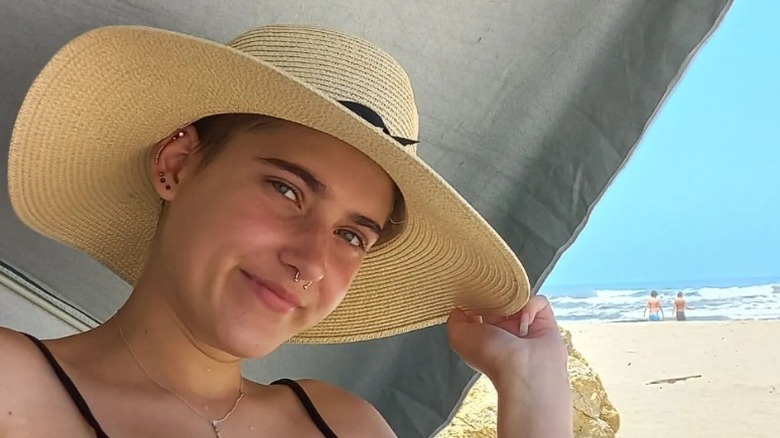 person wearing sun hat on the beach