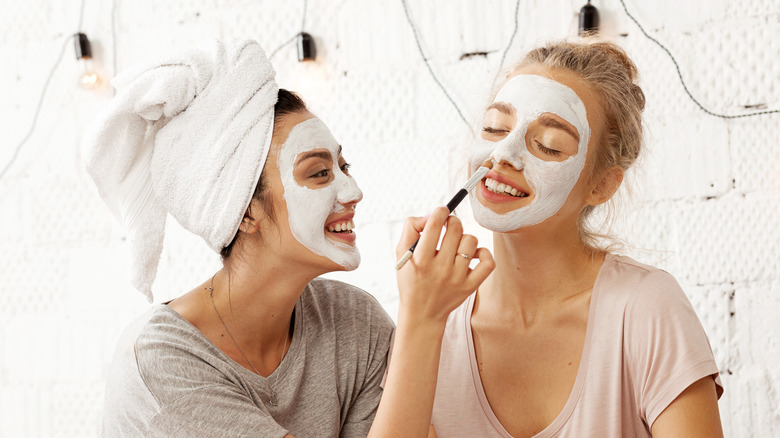 Women applying face masks