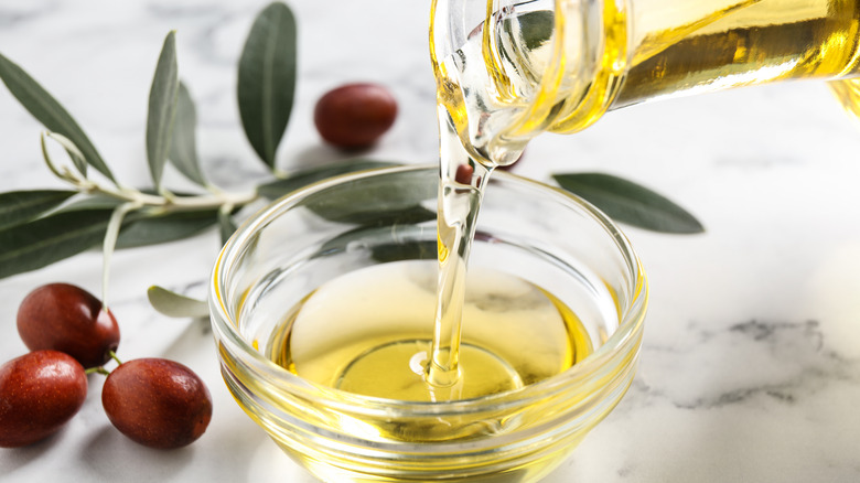 Jojoba oil pouring into bowl