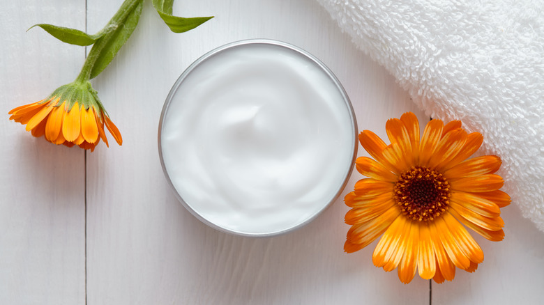 pot of yogurt beside flowers