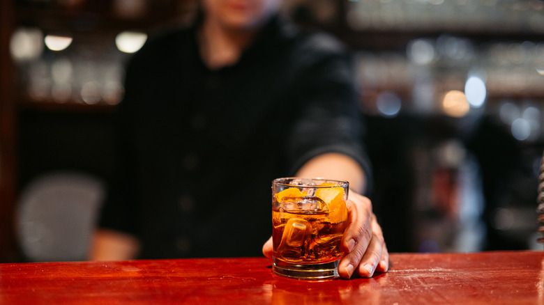 Bartender serving whiskey