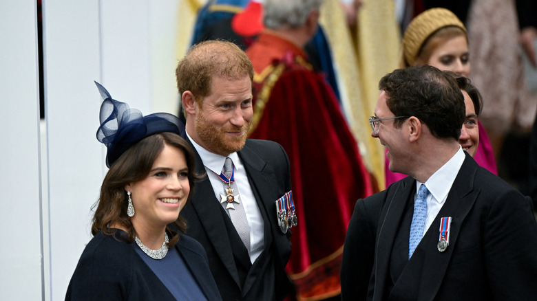 Prince Harry and Princess Eugenie smile standing side by side