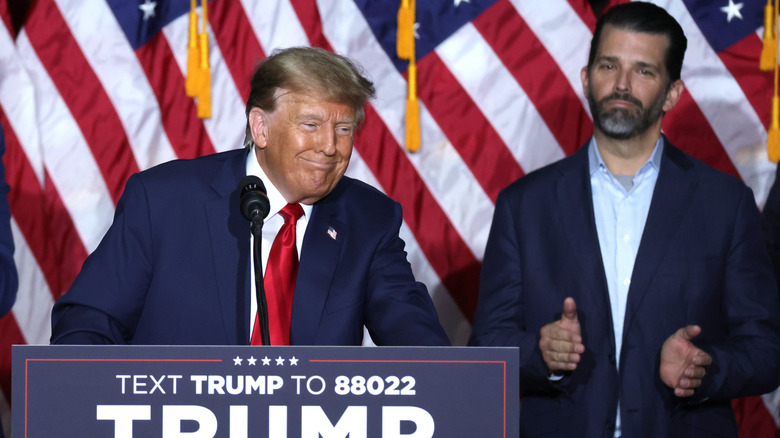 Donald Trump Jr. clapping as his father delivers a speech