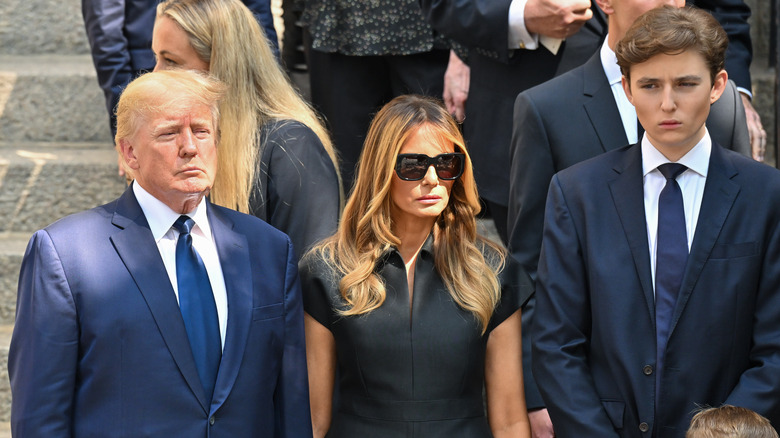 Donald, Melania, and Barron Trump at an event 