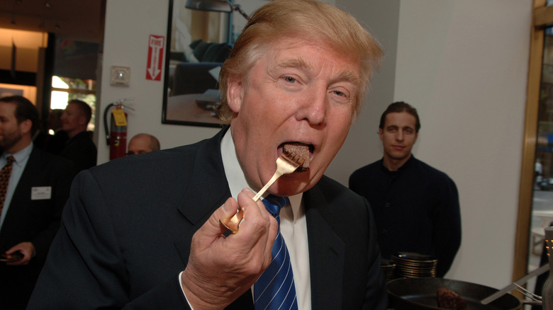 Donald Trump taking a bite of steak