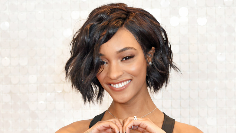 Jourdan Dunn smiling, with hands together