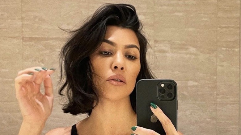 Kourtney Kardashian taking a mirror selfie