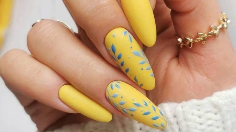 Yellow manicure with blue nail art