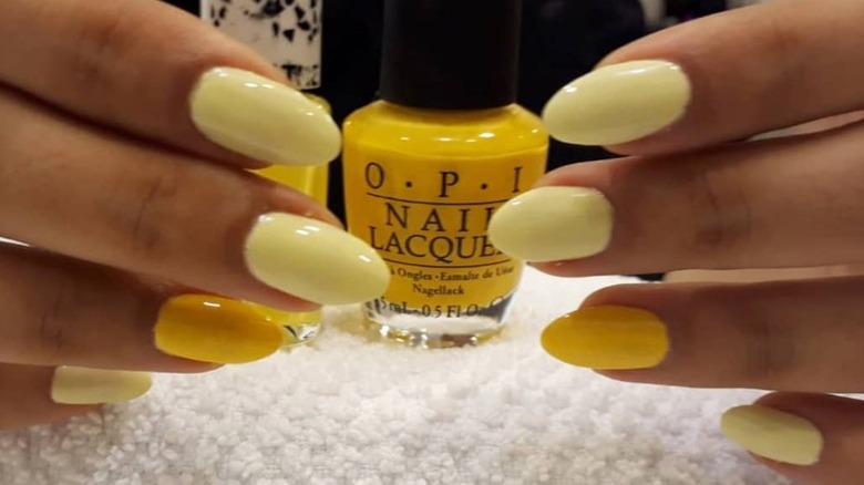 yellow nails with OPI nail polish bottle