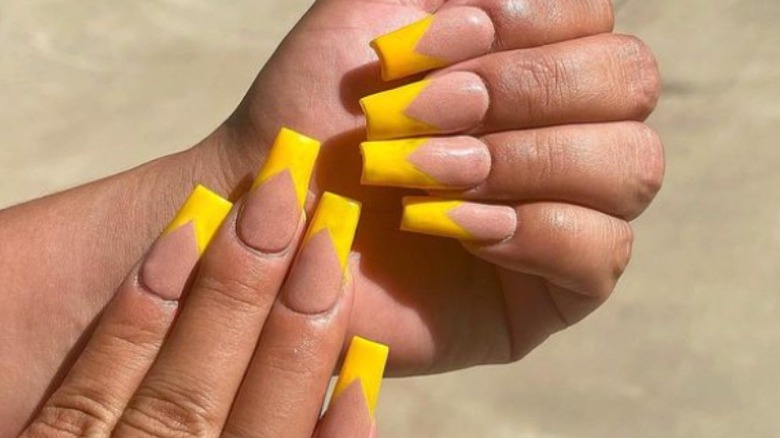 hands with yellow nail art