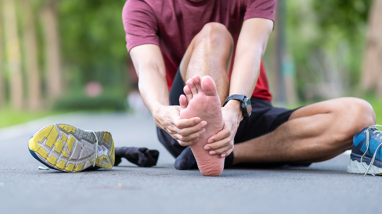 Runner massages feet