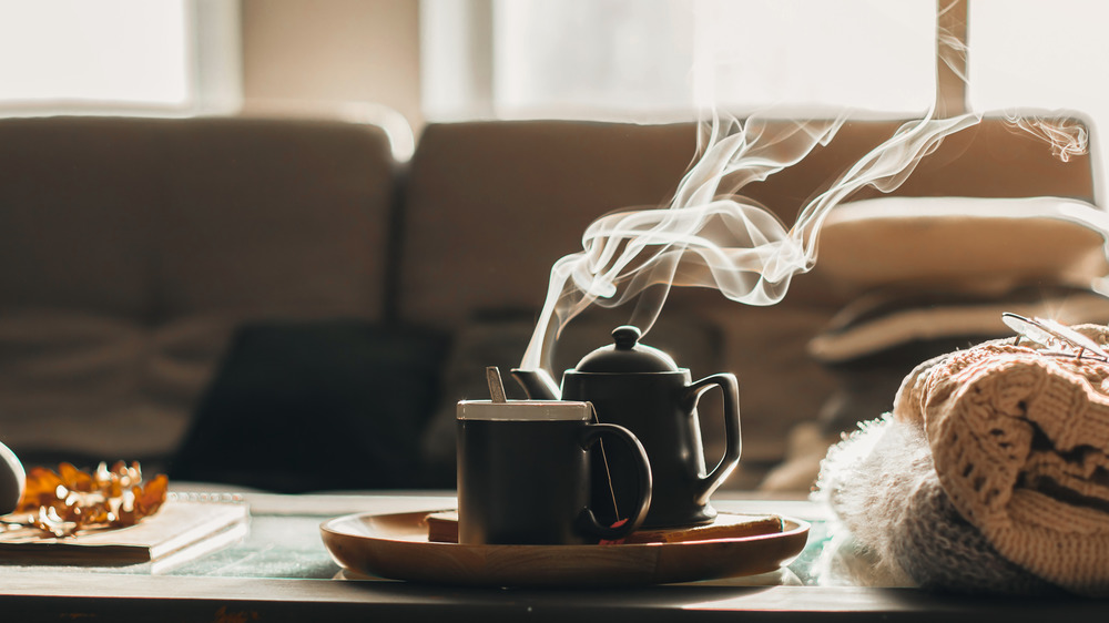 Coffe pot and mug on coffee table in living room 