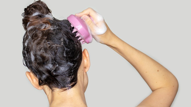 Woman massaging her scalp