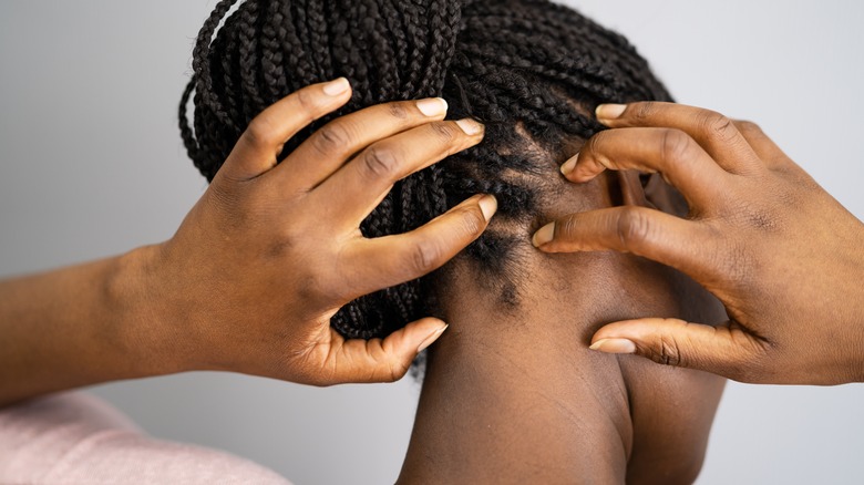 Woman scratching scalp