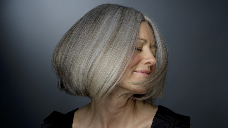 older woman smiling and shaking her hair