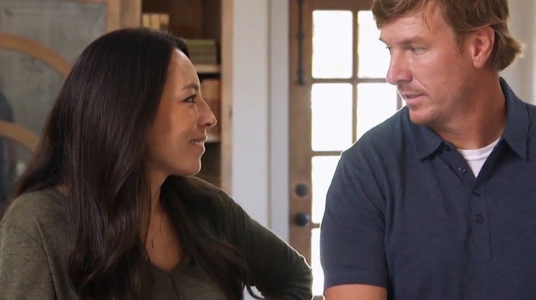 Chip and Joanna Gaines looking at each other lovingly