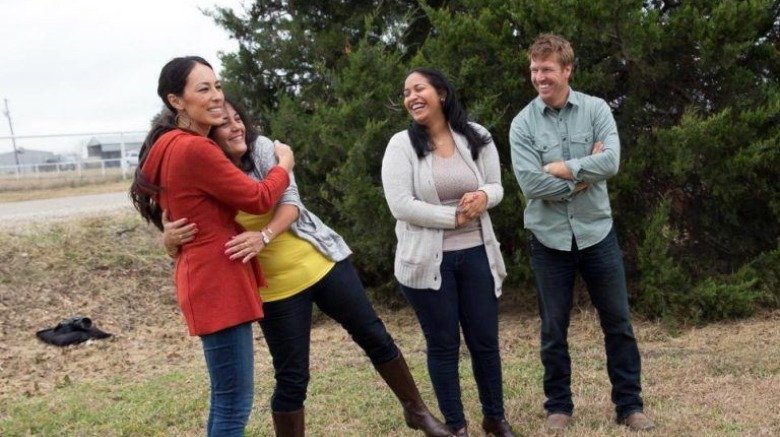 Chip and Joanna Gaines hugging homebuyer