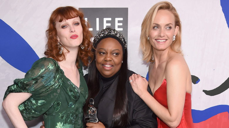 Karen Elson, Amber Valette, and Pat McGrath posing together 