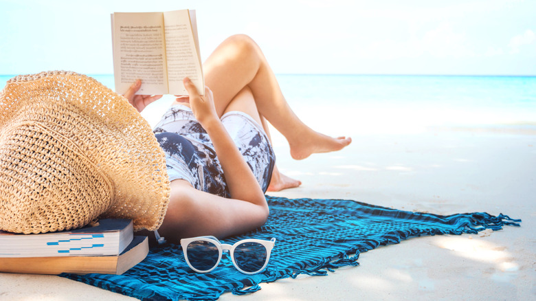 woman reading at the beach