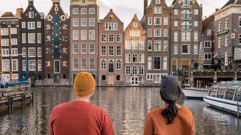 couple sitting in front of a canal in Amsterdam