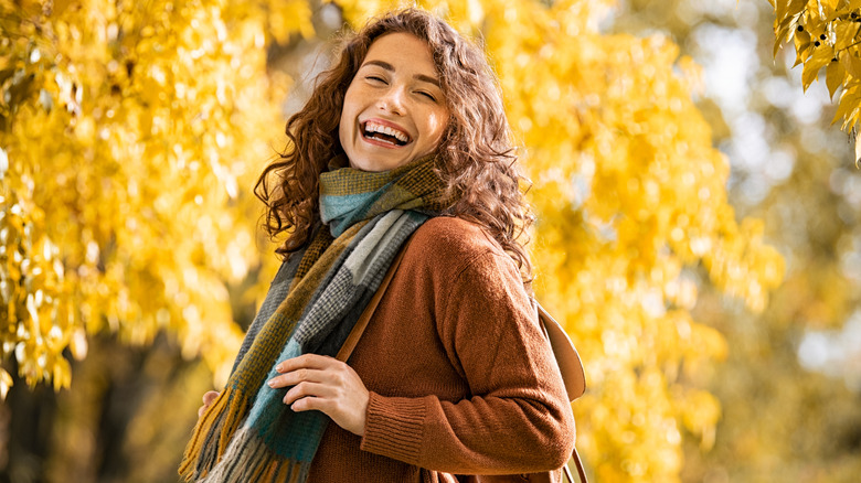 A woman wearing warm clothes in the fall