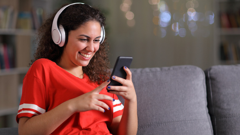 Woman listening to music on smartphone 