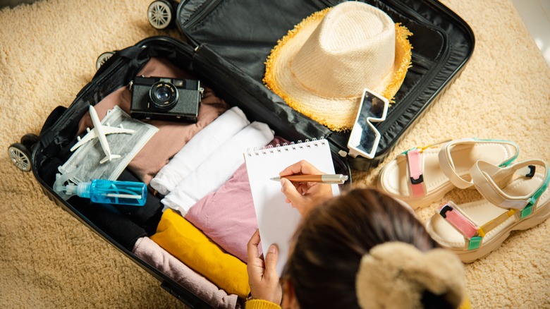 A woman packing for vacation 