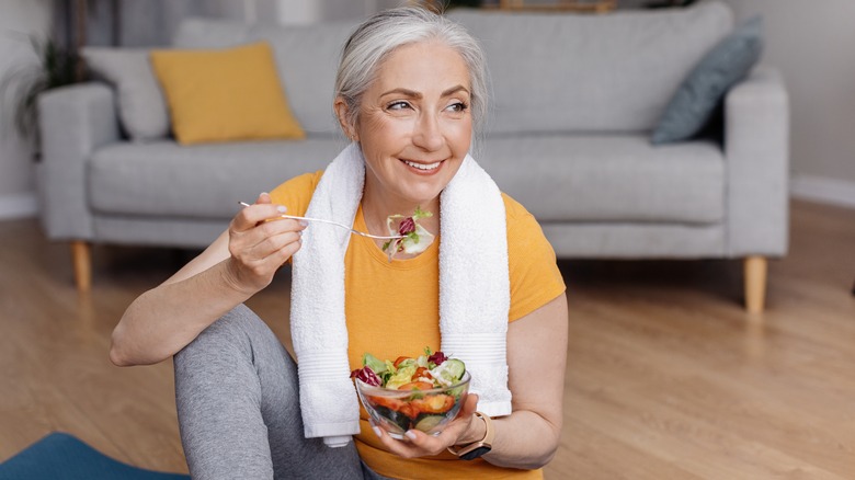 Older woman eating a salad