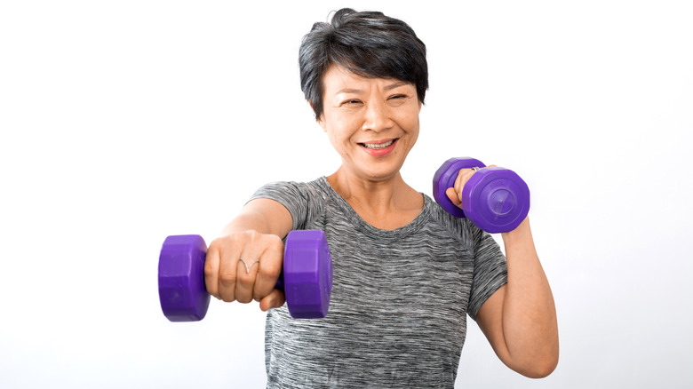 Woman exercising with dumbells
