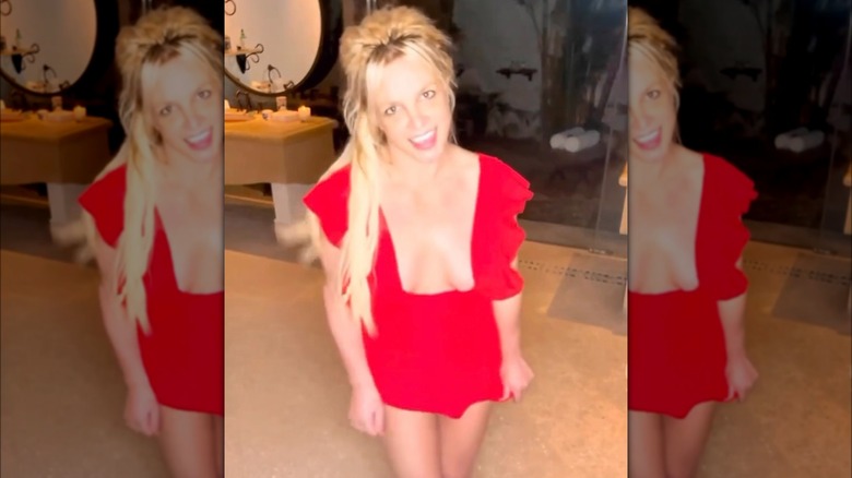 Still image of Britney Spears dancing in a red dress