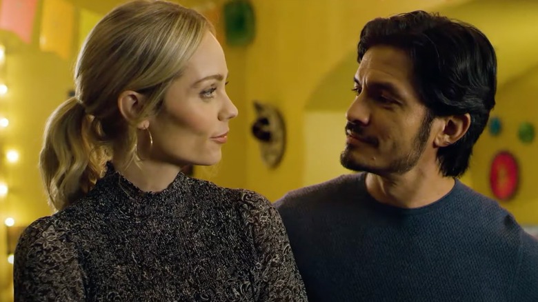 Laura Vandervoort and Nicholas Gonzalez smiling at each other