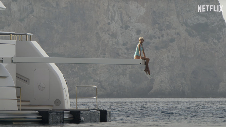 Elizabeth Debicki as Princess Diana sitting on a diving board