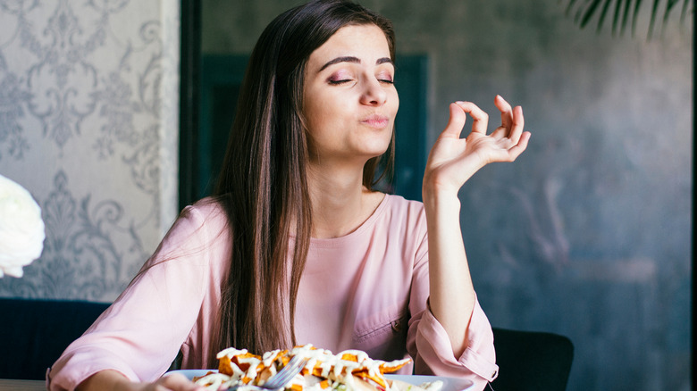 woman enjoying her food alone